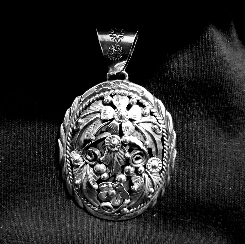 New. Sterling Silver Pendant. Pendant including bail measures 2 3/4 x 1 5/8.
